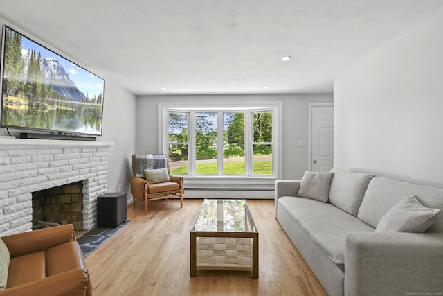 63 Paul Ter, Southington, CT 06489 - living area with baseboard heating, light wood-style floors, and a fireplace