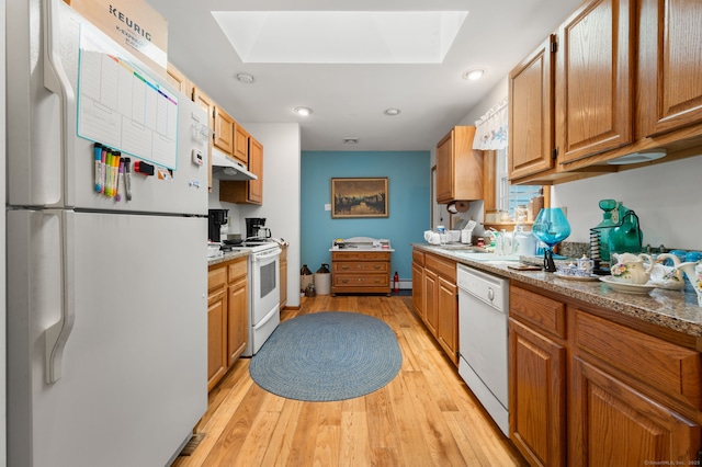 7 Wawecus Hill Rd, Bozrah, CT 06334 - kitchen with white appliances, a skylight, under cabinet range hood, light wood finished floors, and brown cabinetry