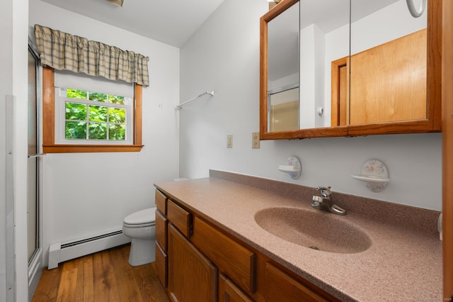 7 Wawecus Hill Rd, Bozrah, CT 06334 - bathroom featuring a baseboard radiator, toilet, vanity, wood finished floors, and a shower with door