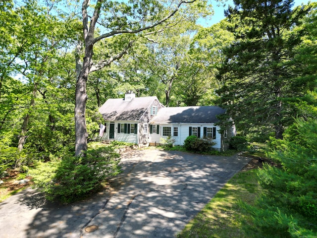 121 Warren Ave, Groton, CT 06355 - view of front of house featuring asphalt driveway, a chimney, and a shingled roof