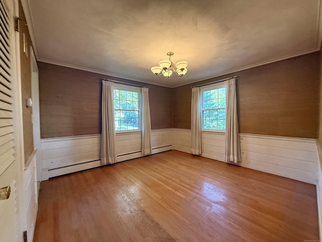 49 Carver Cir, Simsbury, CT 06070 - unfurnished room with a chandelier, a wainscoted wall, healthy amount of natural light, wood finished floors, and crown molding