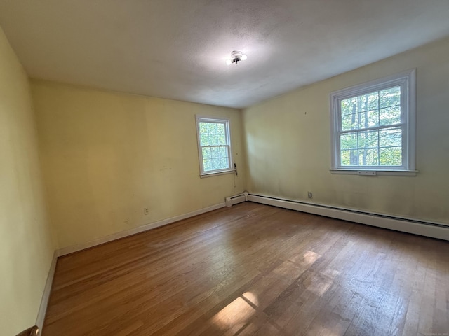 49 Carver Cir, Simsbury, CT 06070 - unfurnished room featuring baseboard heating, wood finished floors, and baseboards