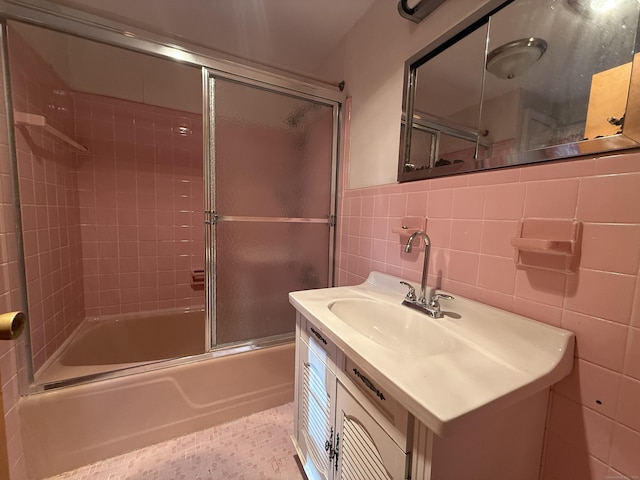 49 Carver Cir, Simsbury, CT 06070 - bathroom with bath / shower combo with glass door, vanity, tile walls, and a wainscoted wall