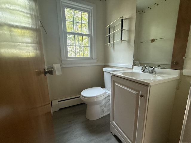 49 Carver Cir, Simsbury, CT 06070 - half bathroom featuring a baseboard heating unit, toilet, vanity, and wood finished floors