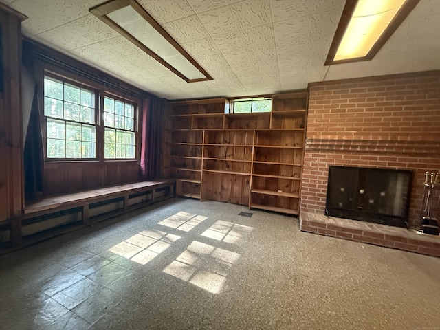 49 Carver Cir, Simsbury, CT 06070 - unfurnished living room with healthy amount of natural light and built in shelves