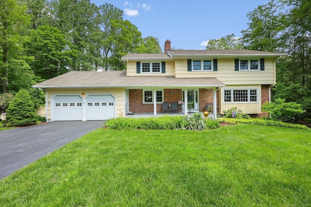 26 Dale Rd, Trumbull, CT 06611 - traditional home with a chimney, covered porch, asphalt driveway, an attached garage, and a front lawn