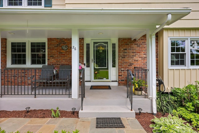 26 Dale Rd, Trumbull, CT 06611 - doorway to property featuring covered porch, board and batten siding, and brick siding