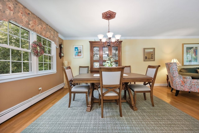 26 Dale Rd, Trumbull, CT 06611 - dining room with baseboard heating, a chandelier, plenty of natural light, wood finished floors, and ornamental molding