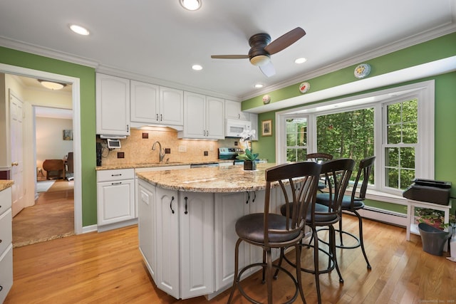 26 Dale Rd, Trumbull, CT 06611 - kitchen featuring a sink, electric range, white microwave, white cabinetry, and crown molding