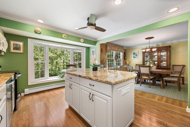 26 Dale Rd, Trumbull, CT 06611 - kitchen with baseboard heating, white cabinets, ceiling fan, light wood finished floors, and ornamental molding
