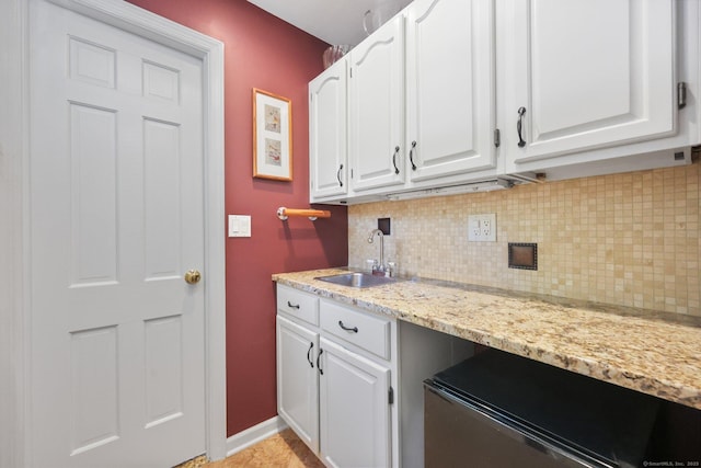 26 Dale Rd, Trumbull, CT 06611 - kitchen featuring a sink, decorative backsplash, white cabinetry, and light stone countertops