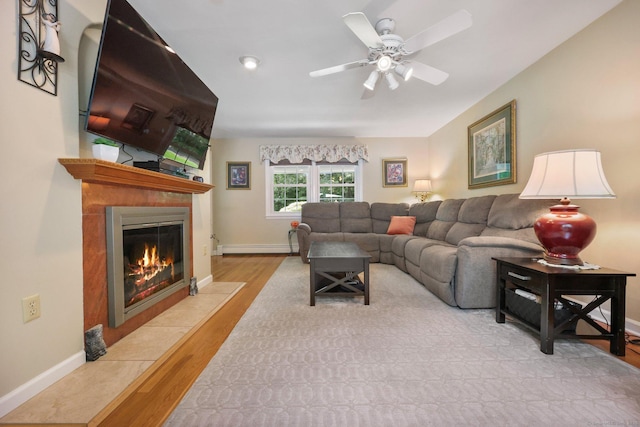 26 Dale Rd, Trumbull, CT 06611 - living room featuring a baseboard radiator, wood finished floors, a tile fireplace, baseboards, and ceiling fan