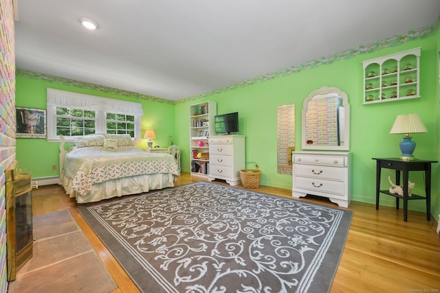 26 Dale Rd, Trumbull, CT 06611 - bedroom featuring wood finished floors, baseboards, and a baseboard radiator