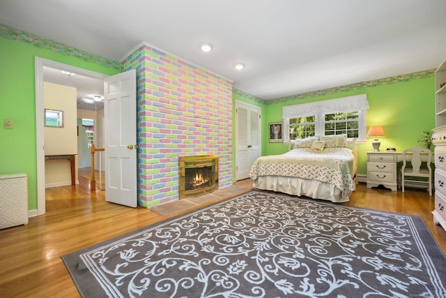 26 Dale Rd, Trumbull, CT 06611 - bedroom with wood finished floors, a baseboard radiator, a closet, and a fireplace
