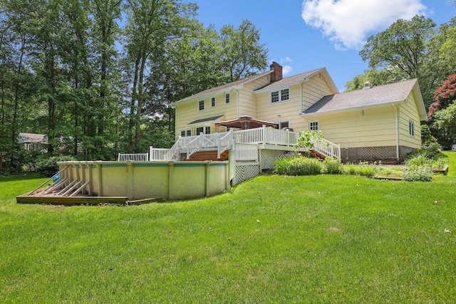 26 Dale Rd, Trumbull, CT 06611 - back of property featuring a wooden deck, a chimney, an outdoor pool, and a yard