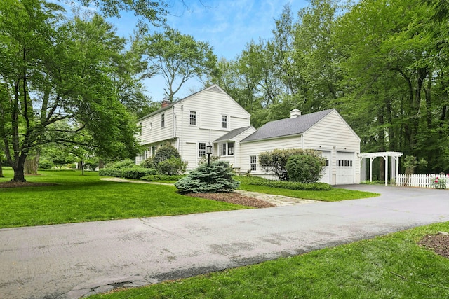 1111 Merwins Ln, Fairfield, CT 06824 - view of front of property featuring a chimney, a garage, and driveway