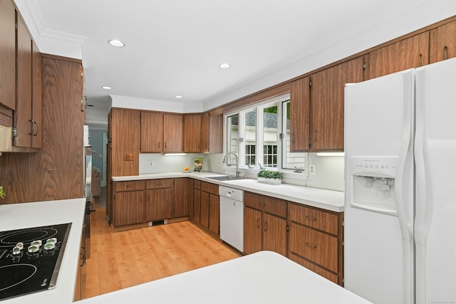 1111 Merwins Ln, Fairfield, CT 06824 - kitchen featuring white appliances, a sink, brown cabinets, light countertops, and light wood finished floors