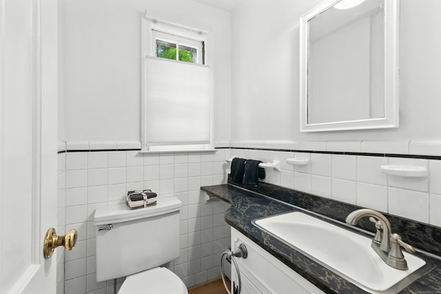 1111 Merwins Ln, Fairfield, CT 06824 - bathroom featuring toilet, vanity, tile walls, and a wainscoted wall