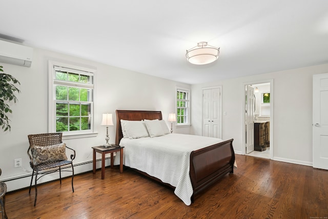 1111 Merwins Ln, Fairfield, CT 06824 - bedroom with a baseboard heating unit, a wall mounted air conditioner, dark wood-style flooring, a closet, and ensuite bath