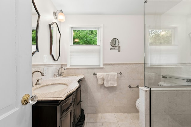 1111 Merwins Ln, Fairfield, CT 06824 - bathroom with double vanity, an enclosed shower, toilet, wainscoting, and tile walls