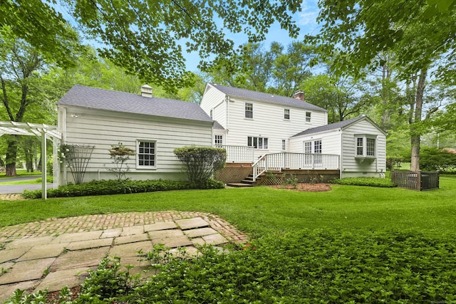 1111 Merwins Ln, Fairfield, CT 06824 - back of house featuring a chimney, a wooden deck, a yard, a shingled roof, and a pergola