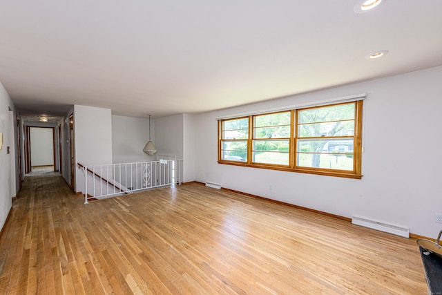 77 Hesse Rd, Hamden, CT 06517 - empty room with baseboard heating, light wood finished floors, and baseboards