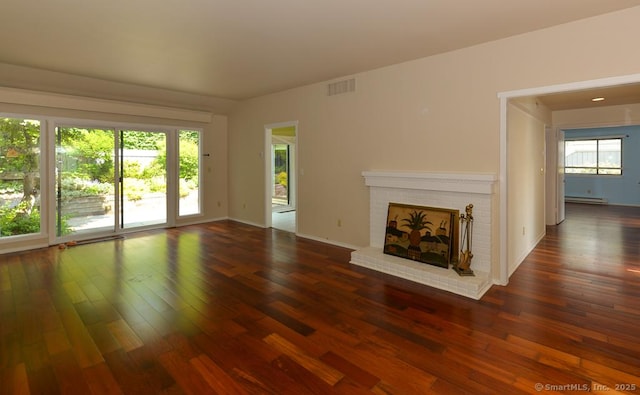 926 Heritage Vlg Unit B, Southbury, CT 06488 - unfurnished living room with a baseboard heating unit, a fireplace, hardwood / wood-style flooring, and baseboards