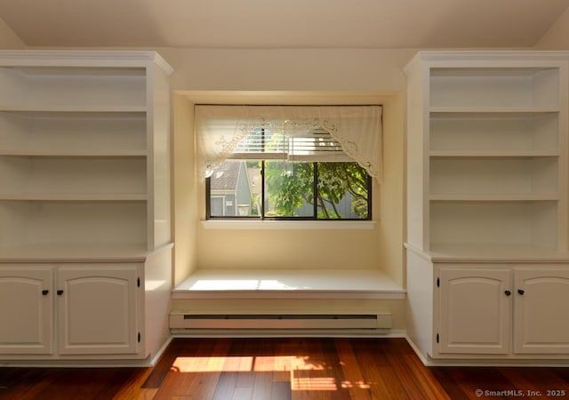 926 Heritage Vlg Unit B, Southbury, CT 06488 - unfurnished room with a baseboard radiator, dark wood-style floors, and built in shelves
