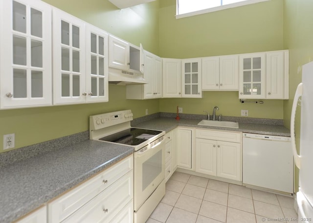 926 Heritage Vlg Unit B, Southbury, CT 06488 - kitchen with white appliances, under cabinet range hood, a sink, light tile patterned flooring, and white cabinetry