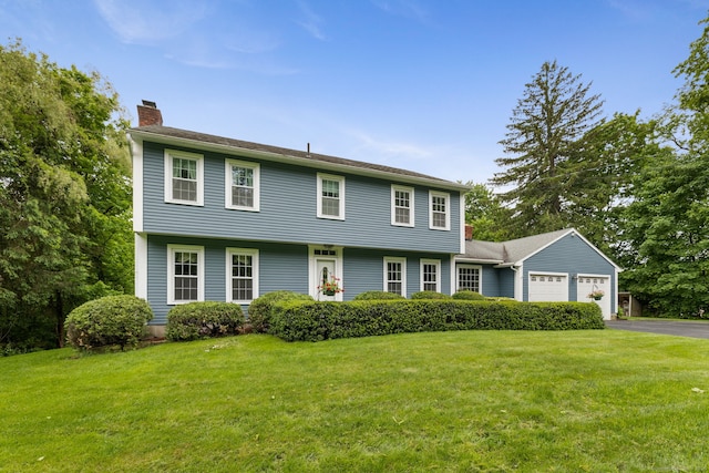 39 Munn Rd, Southbury, CT 06488 - colonial inspired home with a chimney, asphalt driveway, an attached garage, and a front lawn