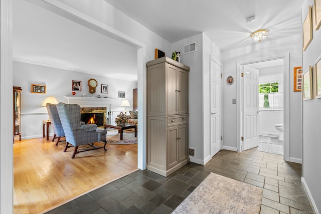 39 Munn Rd, Southbury, CT 06488 - entryway with stone tile flooring, baseboards, and a brick fireplace