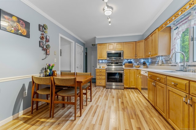39 Munn Rd, Southbury, CT 06488 - kitchen featuring appliances with stainless steel finishes, light wood-type flooring, a sink, tasteful backsplash, and ornamental molding