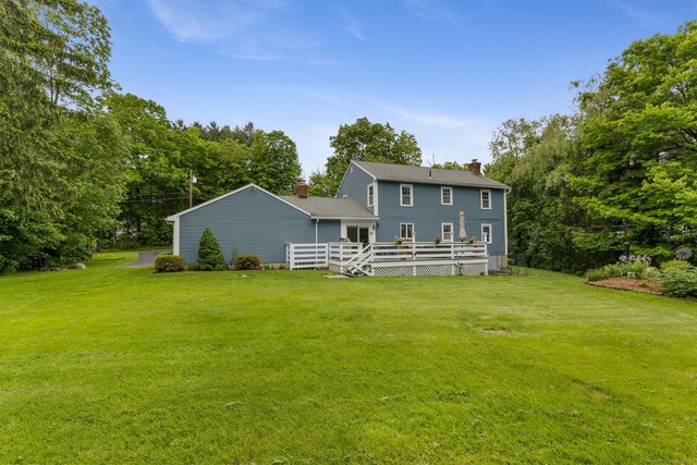 39 Munn Rd, Southbury, CT 06488 - rear view of property featuring a deck, a lawn, and a chimney