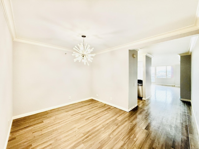 25 Forest St Unit 11A, Stamford, CT 06901 - spare room featuring crown molding, a chandelier, wood finished floors, and baseboards