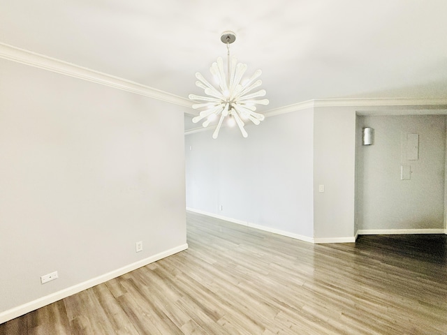 25 Forest St Unit 11A, Stamford, CT 06901 - empty room featuring a chandelier, wood finished floors, ornamental molding, and baseboards