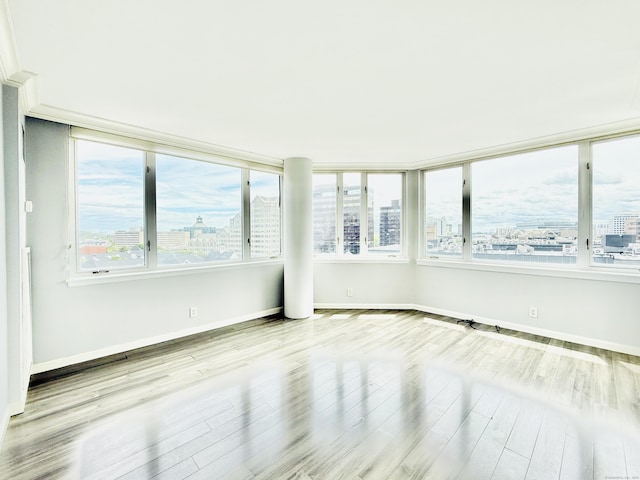 25 Forest St Unit 11A, Stamford, CT 06901 - spare room with a view of city, wood finished floors, healthy amount of natural light, and baseboards