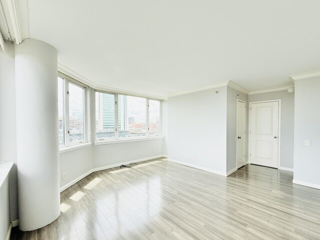 25 Forest St Unit 11A, Stamford, CT 06901 - empty room featuring ornamental molding, light wood finished floors, and baseboards