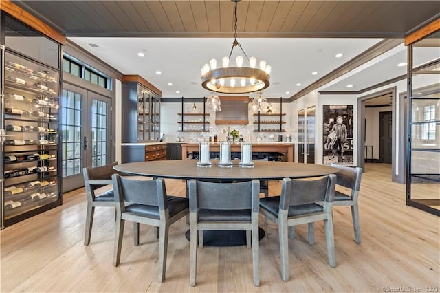 66 High St Unit 17, Guilford, CT 06437 - dining room with light wood finished floors, a chandelier, ornamental molding, recessed lighting, and a community bar