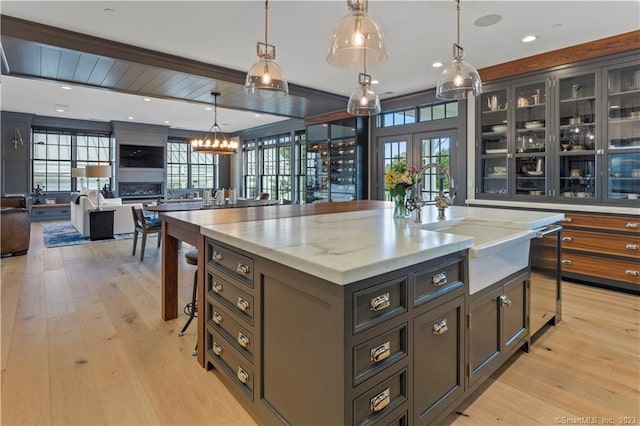 66 High St Unit 17, Guilford, CT 06437 - kitchen with open floor plan, light wood-style flooring, healthy amount of natural light, and a sink