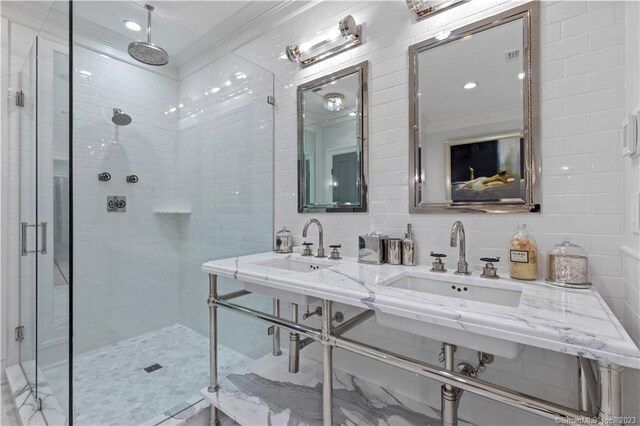 66 High St Unit 17, Guilford, CT 06437 - bathroom featuring a stall shower, ornamental molding, tile walls, double vanity, and tasteful backsplash