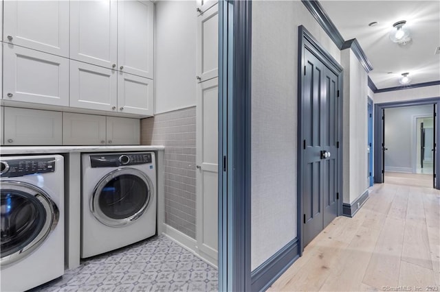66 High St Unit 17, Guilford, CT 06437 - laundry room with separate washer and dryer, cabinet space, ornamental molding, and baseboards