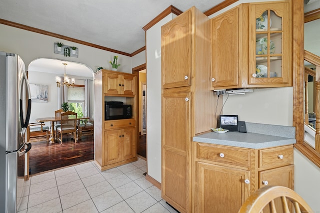687 Beacon Valley Rd, Naugatuck, CT 06770 - kitchen with freestanding refrigerator, arched walkways, a chandelier, black microwave, and light countertops