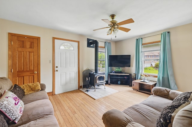 687 Beacon Valley Rd, Naugatuck, CT 06770 - living room featuring a wood stove, ceiling fan, and hardwood / wood-style floors