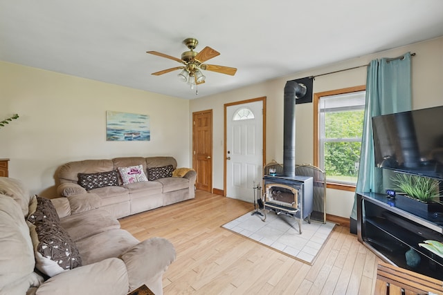 687 Beacon Valley Rd, Naugatuck, CT 06770 - living room with a wood stove, ceiling fan, light wood finished floors, and baseboards