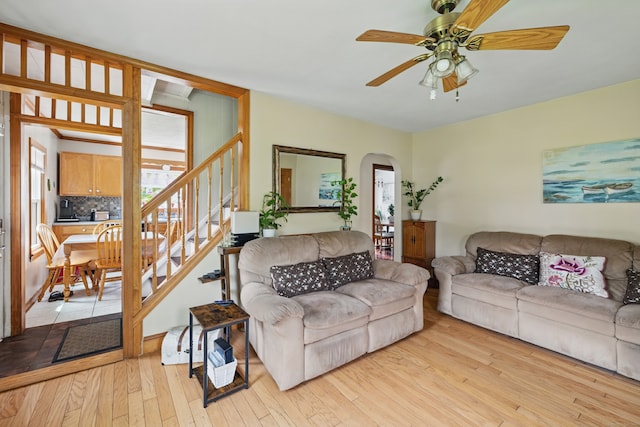 687 Beacon Valley Rd, Naugatuck, CT 06770 - living room featuring stairs, light wood-type flooring, arched walkways, and ceiling fan