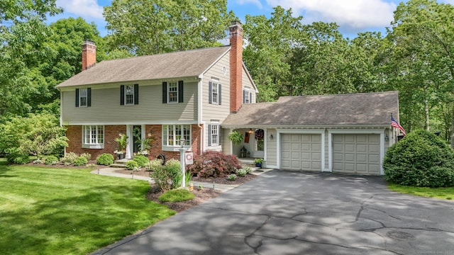 17 Stockade Rd, Simsbury, CT 06092 - colonial-style house with a garage, a chimney, driveway, and a front yard
