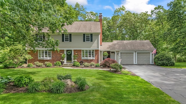 17 Stockade Rd, Simsbury, CT 06092 - colonial home with an attached garage, a chimney, driveway, a front yard, and brick siding