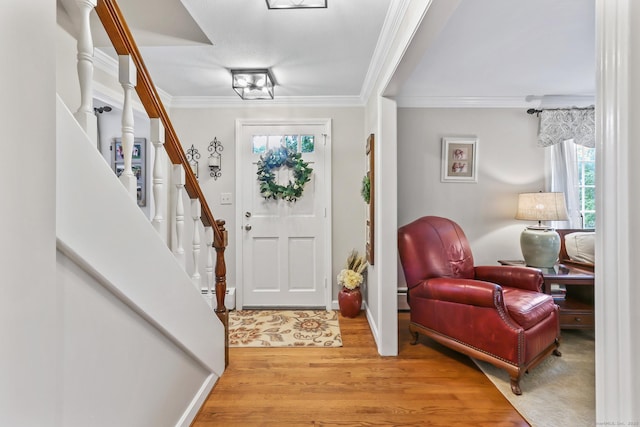 17 Stockade Rd, Simsbury, CT 06092 - entrance foyer with crown molding, light wood-style flooring, baseboards, and a baseboard radiator