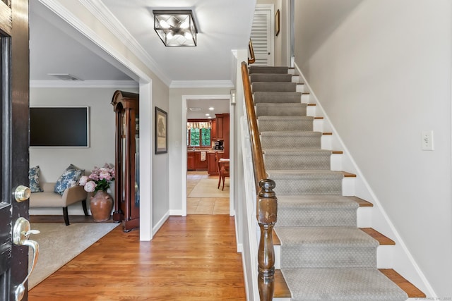 17 Stockade Rd, Simsbury, CT 06092 - entrance foyer with stairs, ornamental molding, light wood-style flooring, and baseboards