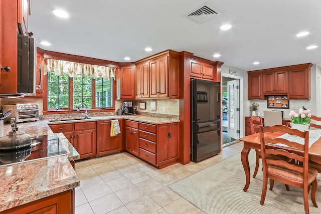 17 Stockade Rd, Simsbury, CT 06092 - kitchen with black appliances, light stone counters, recessed lighting, backsplash, and brown cabinetry